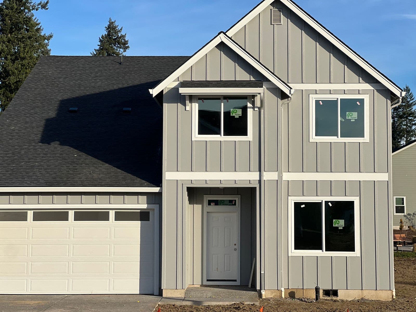 New construction home with board and batten siding by T&M Solution Group
