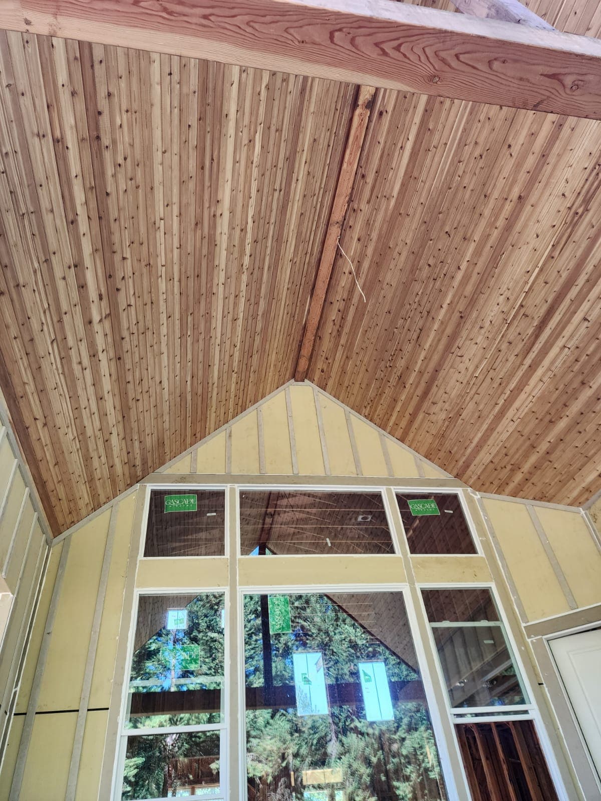 Cedar tongue-and-groove soffit under A-frame overhang with large gable window