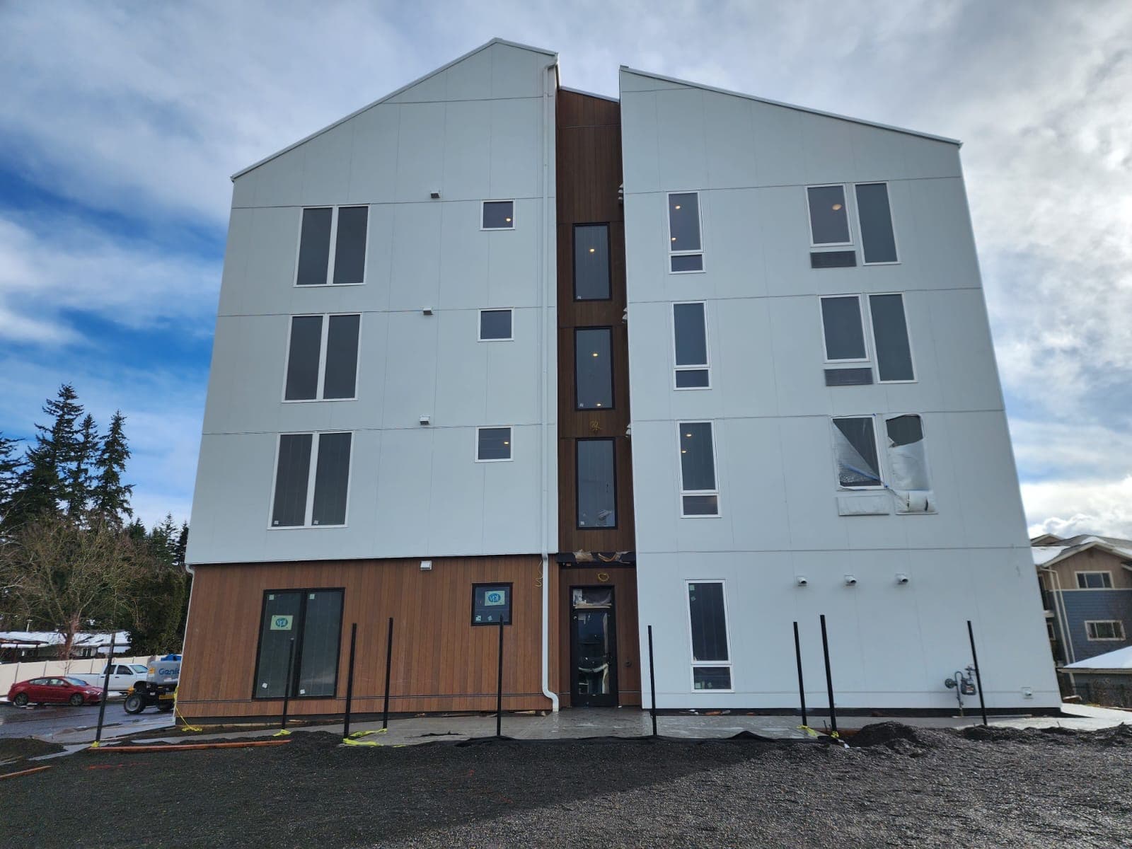 Multi-story commercial building with fiber cement panel siding and wood accent cladding